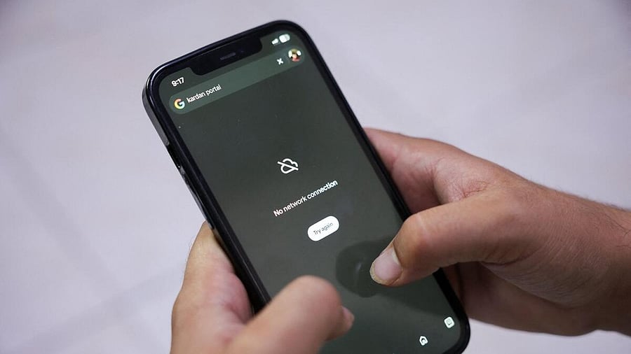 <div class="paragraphs"><p>A man tries to use Google on his smartphone amid total telecom shutdown across the country, in Kabul.</p></div>