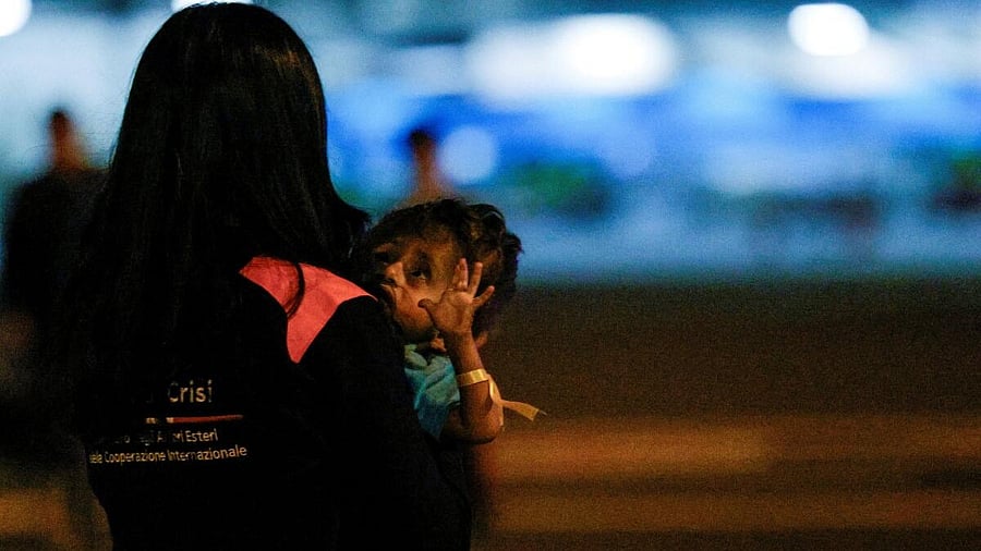 <div class="paragraphs"><p>An operator from the crisis unit of the Ministry of Foreign Affairs holds a Palestinian child who was evacuated from Gaza via a humanitarian airlift and arrived in Italy with relatives for medical treatment, at Ciampino Military Airport in Ciampino, Italy September 29, 2025.</p></div>