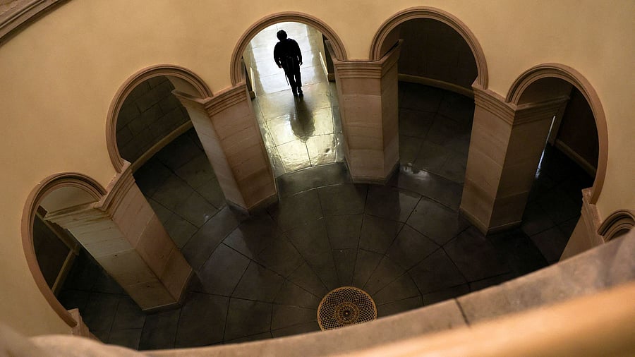 <div class="paragraphs"><p>A worker walks through a hallway at the US Capitol in the hours before a partial government shutdown in Washington</p></div>