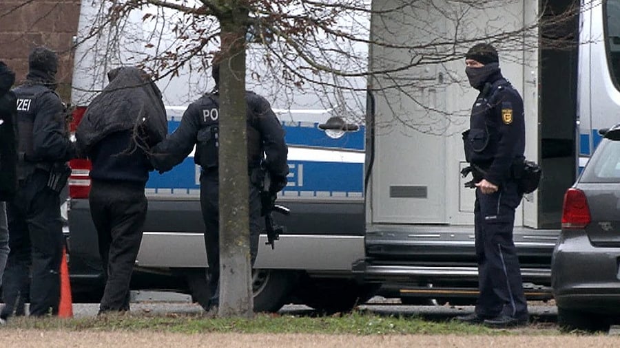 <div class="paragraphs"><p>One arrested suspected Hamas member is escorted by police on his way to the Federal Public Prosecutor in  Germany.</p></div>