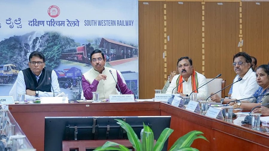<div class="paragraphs"><p>Union Minister Pralhad Joshi at a meeting with South Western Railway officials in Hubballi on Friday.</p></div>