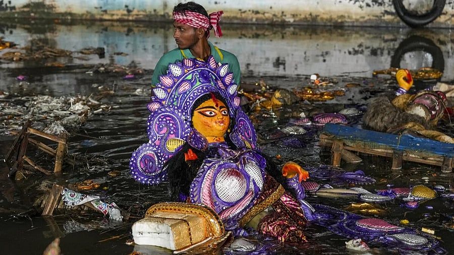 <div class="paragraphs"><p>A worker carries an immersed idol of Goddess Durga out of the Hooghly River on ‘Vijayadashami’, marking the end of the ‘Durga Puja’ festival, at Babughat, in Kolkata, West Bengal</p></div>