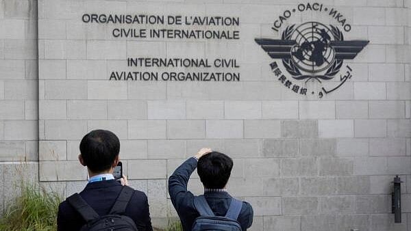 <div class="paragraphs"><p>Members of the International Civil Aviation Organization (ICAO) agency take photos of the logo as they arrive at ICAO headquarters in Montreal, Quebec, Canada.</p></div>