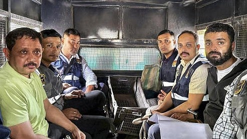<div class="paragraphs"><p>North East India Festival (NEIF) chief organiser Shyamkanu Mahanta and his manager Siddhartha Sharma, alleged to be involved in the death of legendary singer Zubin Garg in Singapore, are brought to the CID office inside a police vehicle.</p></div>