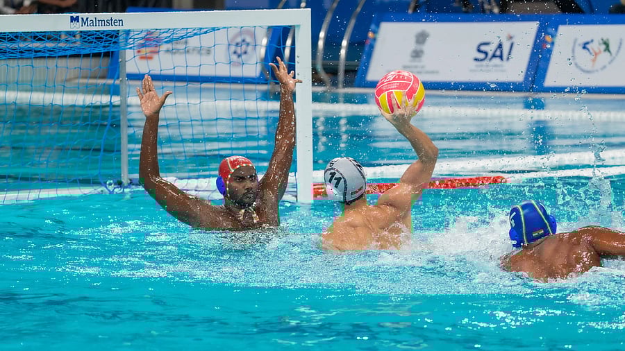 Indian goalkeeper Aneesh Babu (left) prepares to block a shot by Singapore's Jayden See Tien during their group match in Ahmedabad on Saturday.
