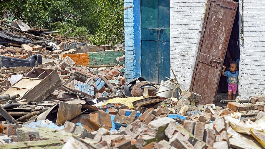 <div class="paragraphs"><p>A child looks at the debris of an unauthorised structure after it was demolished at the slum cluster Janta Colony, in Chandigarh.&nbsp;</p></div>