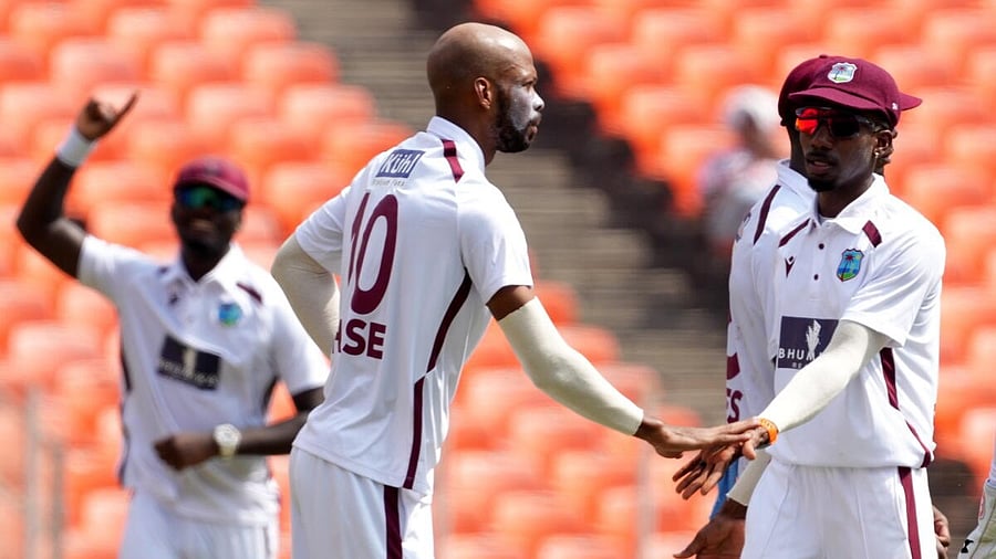 <div class="paragraphs"><p>West Indies' captain Roston Chase celebrates wicket of India's captain Shubman Gill with teammates during the second day of the first Test cricket match between India and West Indies at the Narendra Modi Stadium in Ahmedabad, Gujarat, Friday, Oct. 3, 2025.</p></div>