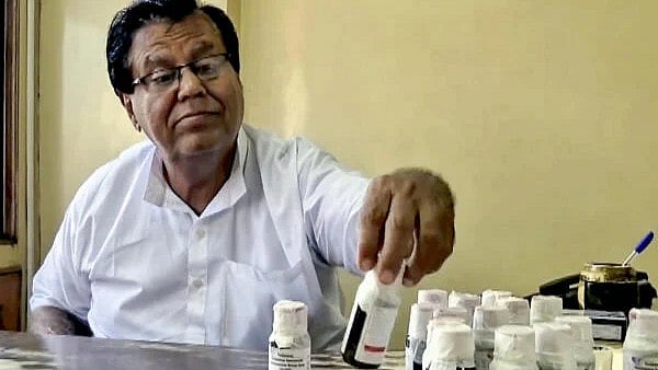 <div class="paragraphs"><p>An official looks at bottles of the ‘Coldrif’ cough syrup after a raid by the Drug and Pharmaceuticals Department officials at Kataria Pharmaceuticals, after the deaths of 11 children, nine in Madhya Pradesh and two in Rajasthan, allegedly linked to contaminated cough syrup, in Jabalpur, Madhya Pradesh.</p></div>