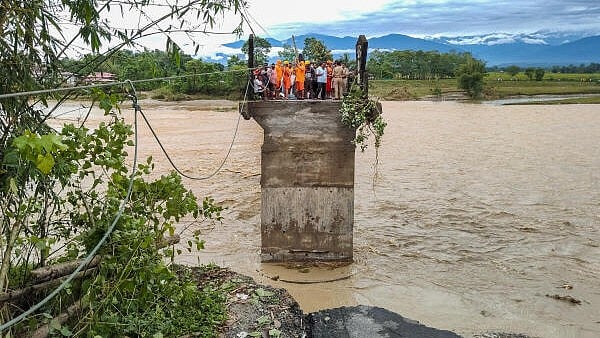 <div class="paragraphs"><p>Rescue operation underway after a bridge collapses in the landslides hit area following heavy rainfall, in Darjeeling.</p></div>