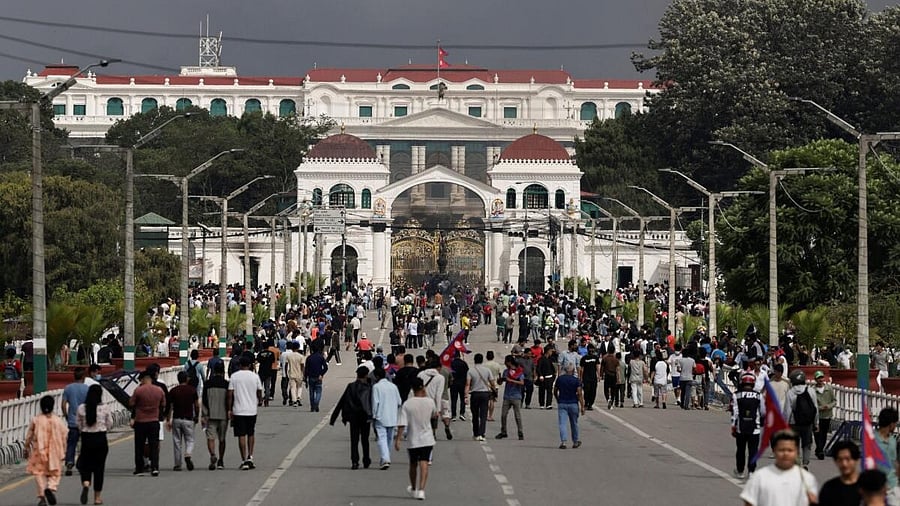 <div class="paragraphs"><p>Demonstrators gather outside Singha Durbar office complex that houses the prime minister's office and other ministries, before it was ransacked and burned during the protest against anti-corruption triggered by a social media ban, which was later lifted, in Kathmandu, Nepal.</p></div>