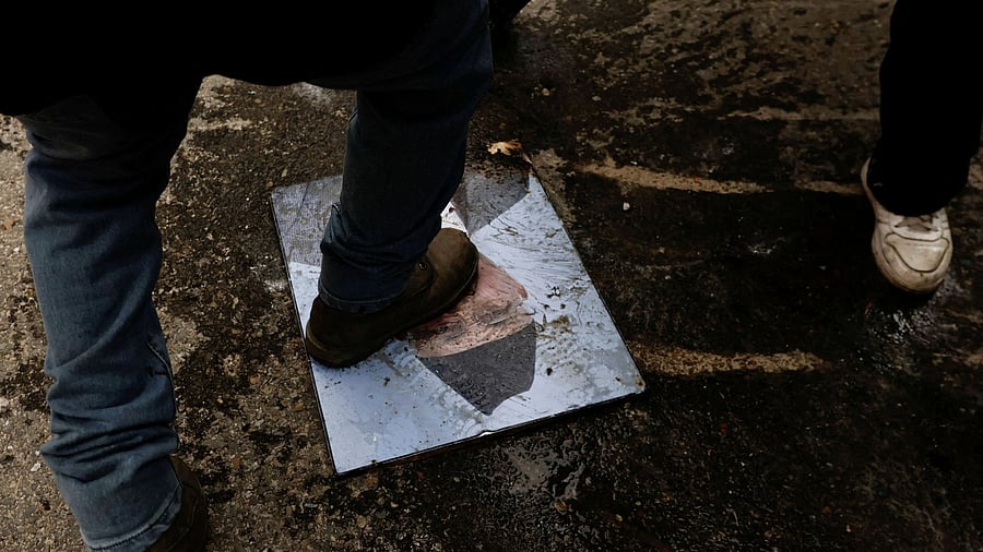 <div class="paragraphs"><p>A demonstrator steps on the portrait of KP Sharma Oli, who resigned as Nepal's Prime Minister.</p></div>