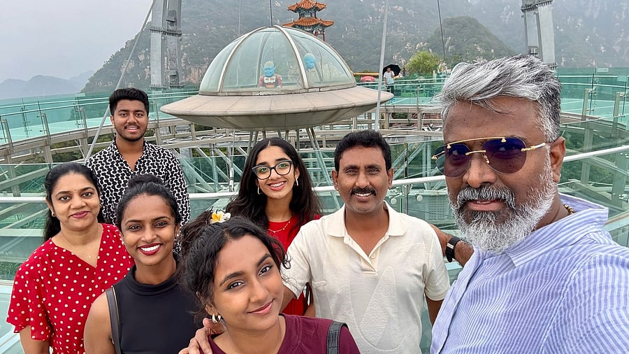 E Lakshminarayan Reddy (second from right) at a glass bridge in Shilinxia near Beijing last month. He is seen with his family and friends.