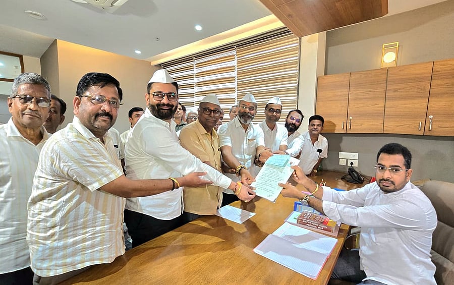 <div class="paragraphs"><p>BDCC Bank former chairman and sitting director Ramesh Katti submits nomination papers for the post of director from Hukkeri in Belagavi on Tuesday. MLA Nikhil Katti, Vinay Patil and others are seen. </p></div>
