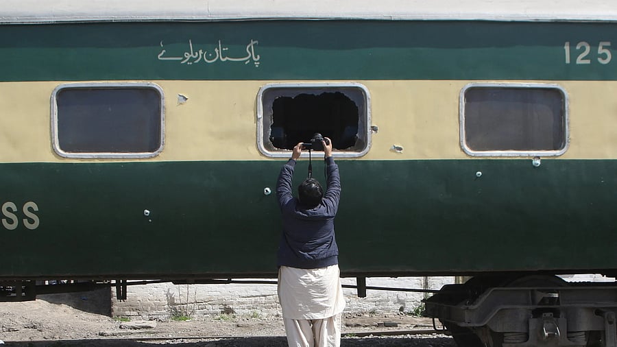 <div class="paragraphs"><p>A cameraman films the Jaffar Express train, riddled with bullet holes, after it was attacked by separatist militants in Bolan, at the Railway Station in Quetta, Balochistan, Pakistan, March 19, 2025. </p></div>