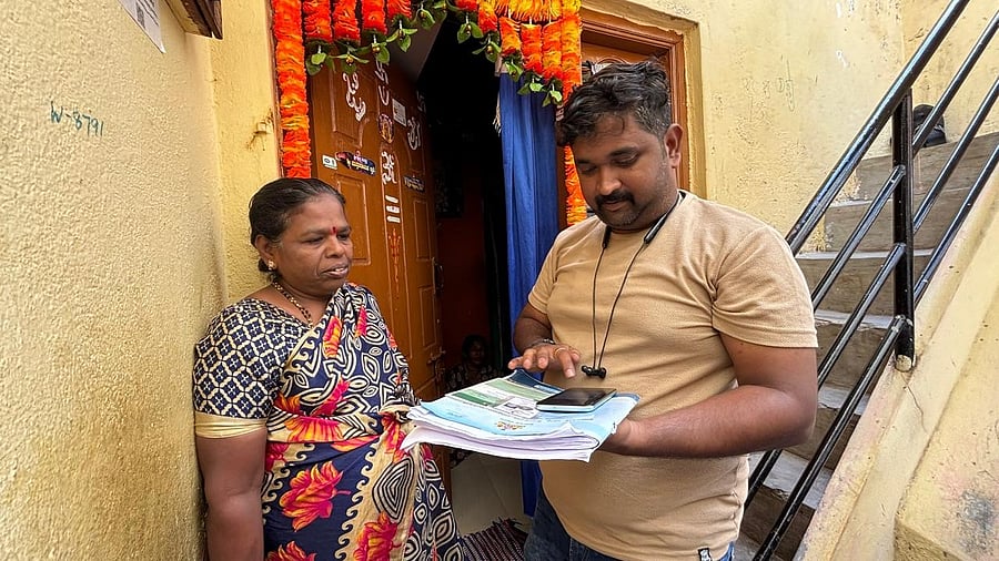 <div class="paragraphs"><p>An enumerator fills in the details during the socio-educational survey in Swantantrapalya, Srirampura, on Tuesday. </p></div>