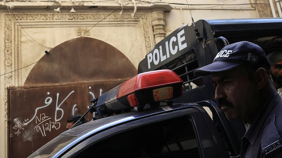 <div class="paragraphs"><p>A police officer stands in front of a place of worship of the Ahmadi minority community.</p></div>