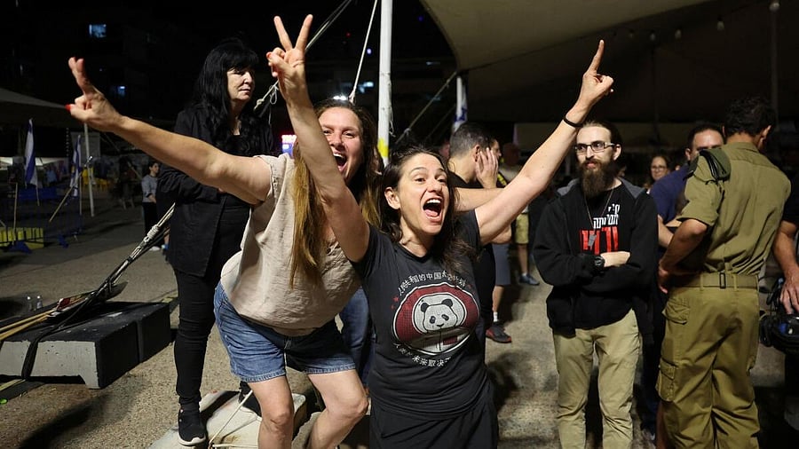 <div class="paragraphs"><p>People celebrate, after U.S. President Donald Trump announced that Israel and Hamas agreed on the first phase of a Gaza ceasefire, at the "Hostages square", in Tel Aviv, Israel.</p></div>