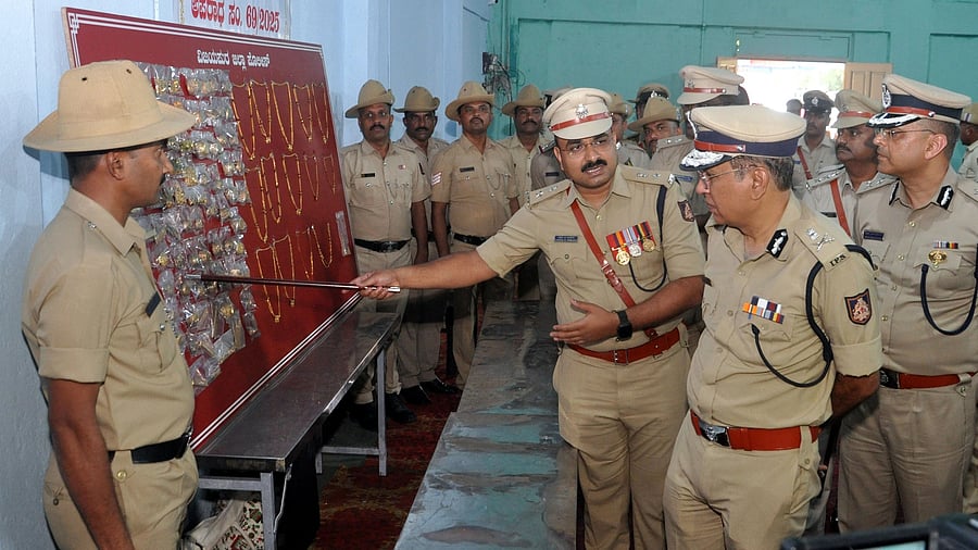 District Superintendent of Police Lakshman Nimbargi shows recovered gold jewellery to ADGP R Hitendra in Vijayapura on Thursday. They had been stolen from the SBI branch at Chadchan in the district on September 16. IGP (northern range) Chetan Singh Rathod and other police officers look on. DH Photo