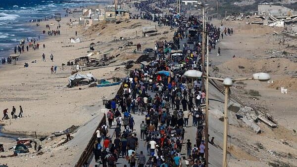 <div class="paragraphs"><p>Palestinians, who were displaced to the southern part of Gaza at Israel's order during the war, make their way along a road as they return to the north after a ceasefire.</p></div>