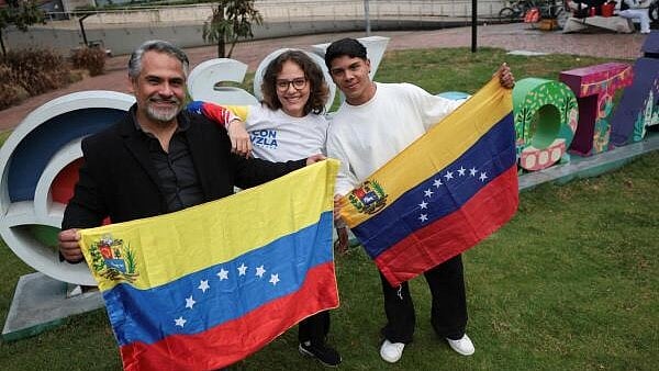 <div class="paragraphs"><p>Mauricio Baquero, Sofia Rojas and Josue Marin, members of Maria Corina Machado's Vente Venezuela party, pose for a photo with the Venezuelan flag on the day the Norwegian Nobel Committee announced Machado as the winner of the 2025 Nobel Peace Prize, in Bogota, Colombia.</p></div>