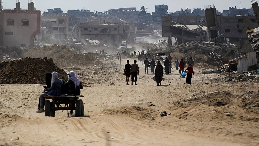 <div class="paragraphs"><p>Palestinians walk near rubble, after Israeli forces withdrew from the area, following a ground operation, amid the ongoing conflict between Israel and Hamas, in Khan Younis, in the southern Gaza Strip, August 30, 2024. </p></div>
