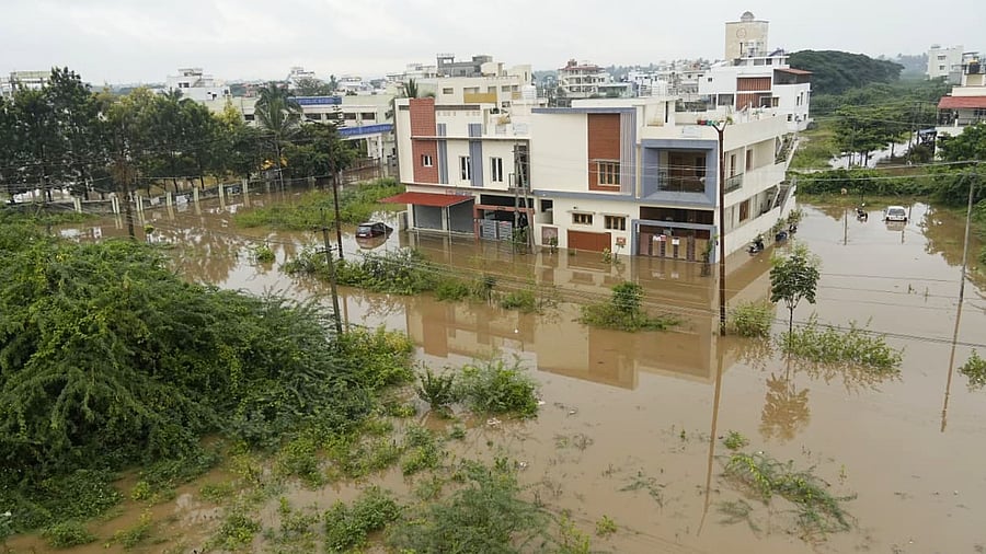 A heavy rain in the intervening night of Thursday and Friday marooned the KHB Colony in Mandya. DH Photo