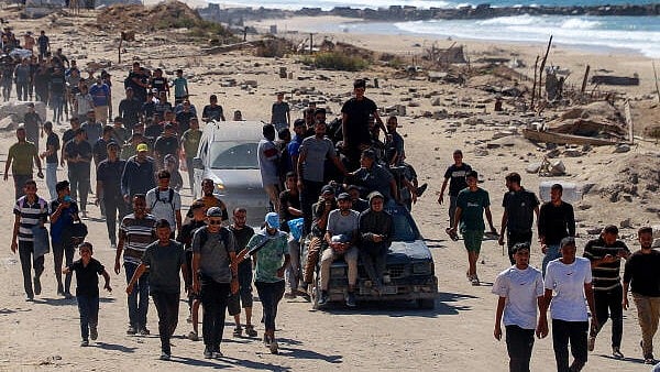 <div class="paragraphs"><p>Palestinians, who were displaced to the southern part of Gaza at Israel's order during the war, make their way following their arrival in Gaza City after a ceasefire between Israel and Hamas.</p></div>