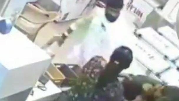 <div class="paragraphs"><p>A screengrab from the CCTV footage shows the suspect in white attacking the victim and his wife. </p></div>