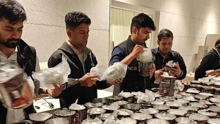 <div class="paragraphs"><p>NCB officers examine seized contraband at Bengaluru airport. </p></div>