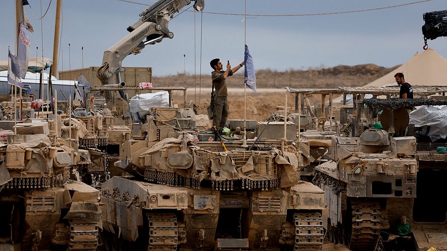<div class="paragraphs"><p>An Israeli soldier stands on a military vehicle near the Israel-Gaza border, amid a ceasefire between Israel and Hamas in Gaza.</p></div>
