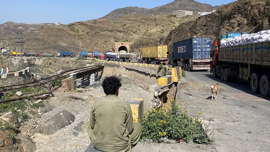 <div class="paragraphs"><p>A man sits next to trucks parked at the Torkham border crossing, after Pakistan closed border crossings with Afghanistan, following exchanges of fire between the forces of the two countries, in Torkham, Pakistan, October 12, 2025.</p></div>