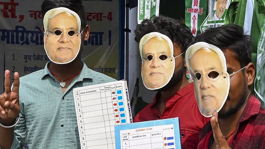 <div class="paragraphs"><p>Janata Dal (United) supporters wear masks of CM Nitish Kumar and hold EVM replicas as they gear up for the Bihar Assembly election 2025 campaign, in Patna, Bihar, Sunday, Oct. 12, 2025.</p></div>