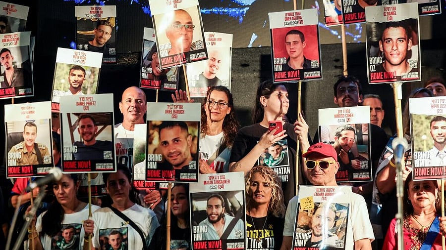 <div class="paragraphs"><p>People hold placards with pictures of hostages who were kidnapped in the deadly October 7, 2023 attack by Hamas, after a ceasefire between Israel and Hamas in Gaza went into effect, at "Hostages square" in Tel Aviv, Israel, October 11, 2025.</p></div>