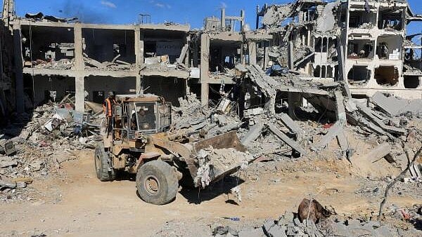 <div class="paragraphs"><p>Heavy machinery removes debris from a street, amid a ceasefire between Israel and Hamas in Gaza.</p></div>
