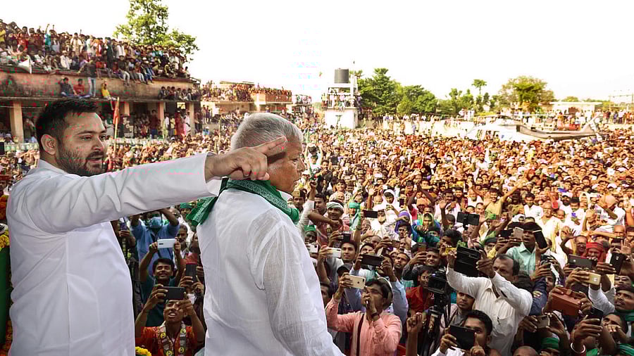 <div class="paragraphs"><p>Rashtriya Janata Dal chief Lalu Prasad, along with son and party leader Tejashwi Yadav, addresses a campaign rally.</p></div>