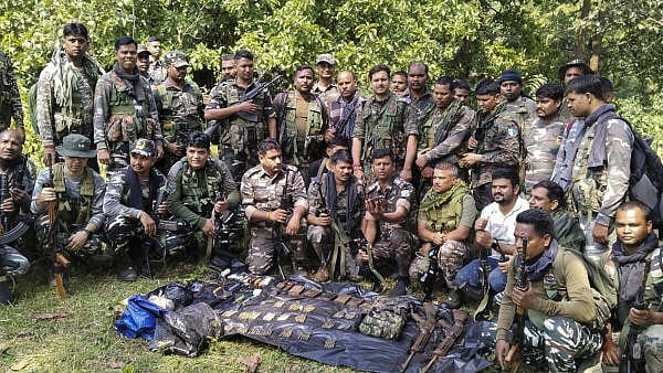 <div class="paragraphs"><p>Security personnel pose with a cache of arms recovered from forest areas during a joint anti-Naxal operation. (Representative file image)</p></div>