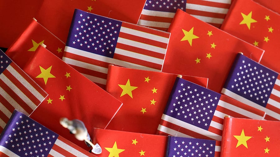 <div class="paragraphs"><p> China and U.S. flags are displayed alongside a miniature worker in this illustration.</p></div>