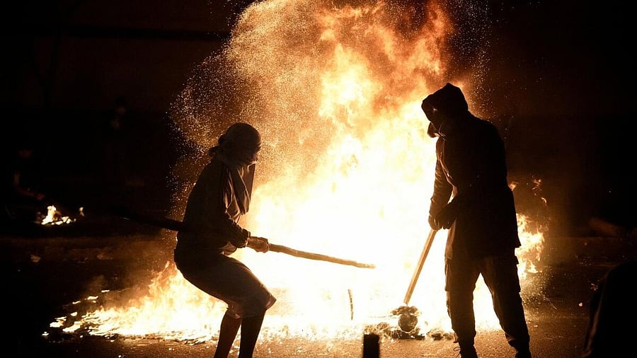 <div class="paragraphs"><p>Demonstrators stand next to fire burning during a protest against rising crime, economic insecurity, and corruption, a day after President Jose Jeri presented his cabinet, in Lima, Peru.</p></div>