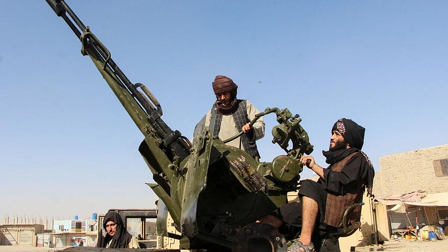 <div class="paragraphs"><p>An Afghan Taliban fighter sit next to an anti-aircraft gun near the Afghanistan-Pakistan border.</p></div>