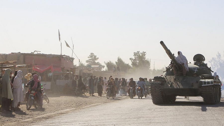 <div class="paragraphs"><p>An Afghan Taliban fighter sits on a tank near the Afghanistan-Pakistan border in Spin Boldak.</p></div>