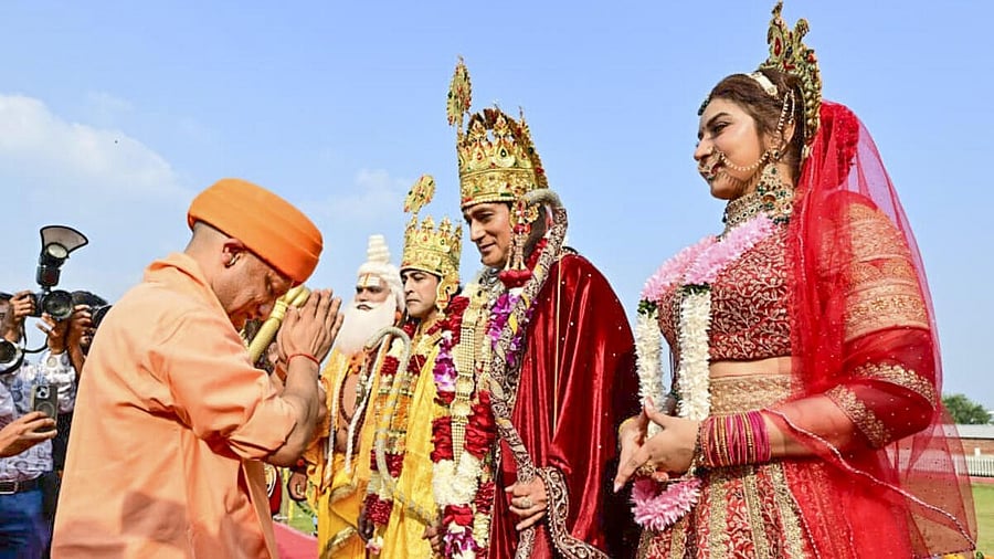 <div class="paragraphs"><p>Uttar Pradesh Chief Minister Yogi Adityanath greets artistes dressed as Lord Rama, Goddess Sita and Lord Lakshmana and other Hindu deities during a procession ahead of the ‘Deepotsav’ celebration, in Ayodhya. </p></div>