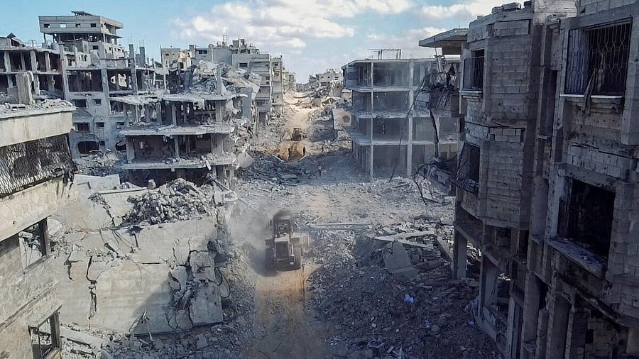 <div class="paragraphs"><p>A drone view shows heavy machinery operating around a destroyed residential neighbourhood.</p></div>