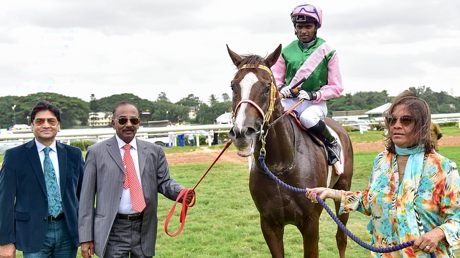 <div class="paragraphs"><p>Trainer Padmanabhan (left) with the all-conquering Desert God, a horse that he bred, owned and trained. On the right is his wife Sharmila. </p></div>