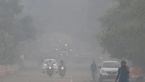 <div class="paragraphs"><p>Vehicles move on a road shrouded in smog on the morning of Diwali in Delhi.&nbsp;</p></div>