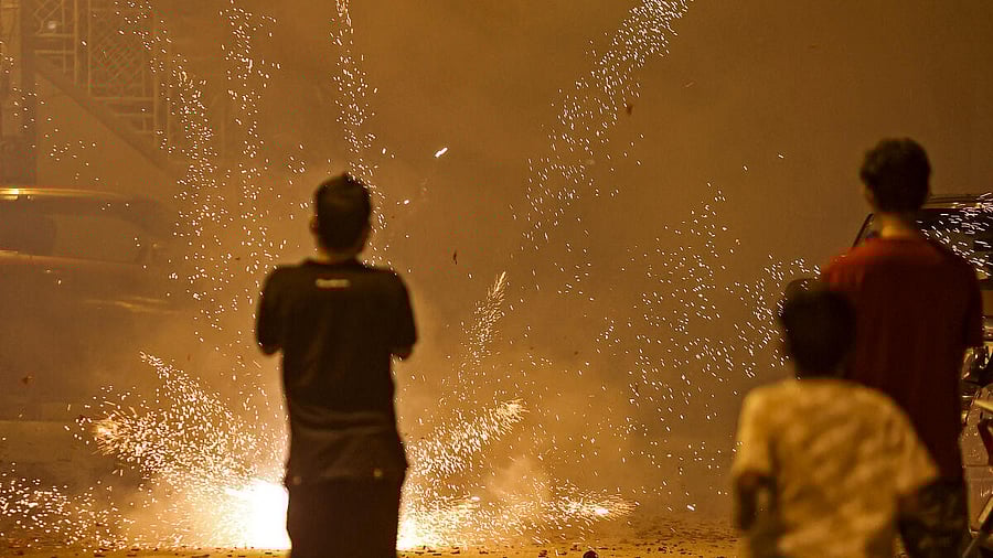 <div class="paragraphs"><p>People burst firecrackers as part of Diwali festival celebrations, in Bengaluru.</p></div>