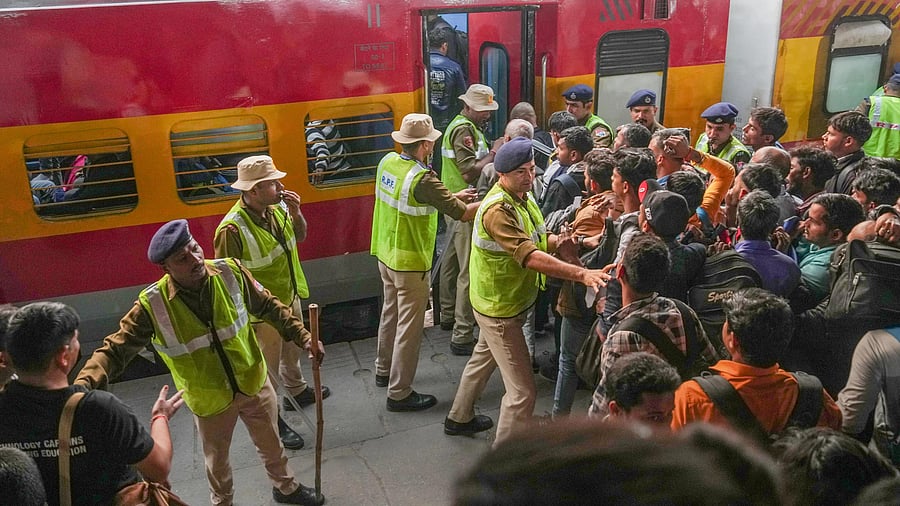 <div class="paragraphs"><p>Security personnel attempt to control passengers rushing to board a train to travel home for the 'Chhath Puja' festival. Image for representational purpose.</p></div>
