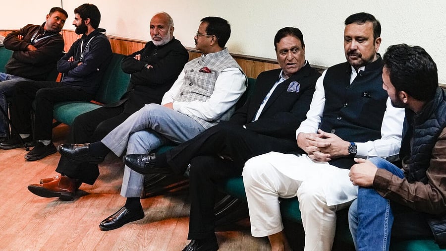 <div class="paragraphs"><p>National Conference candidates Sajjad Ahmad Kichloo (second from right) and Choudhary Muhammad Ramzan (third from right), along with others, during voting for the four Rajya Sabha seats at the Jammu and Kashmir Legislative Assembly in Srinagar on Friday.</p></div>