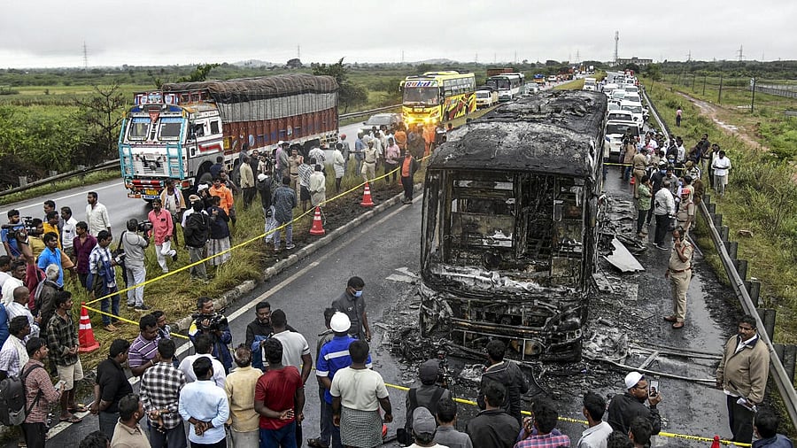 <div class="paragraphs"><p>Police personnel and others gather near a Bengaluru-bound private bus that caught fire after colliding with a two-wheeler</p></div>