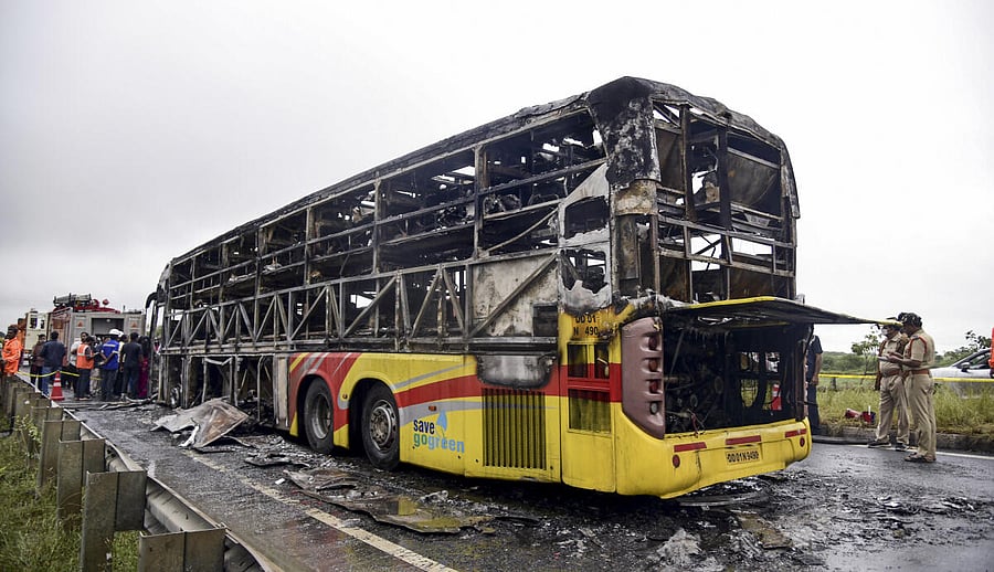 <div class="paragraphs"><p>Police personnel investigate the spot where a Bengaluru-bound private bus caught fire after colliding with a two-wheeler.</p></div>