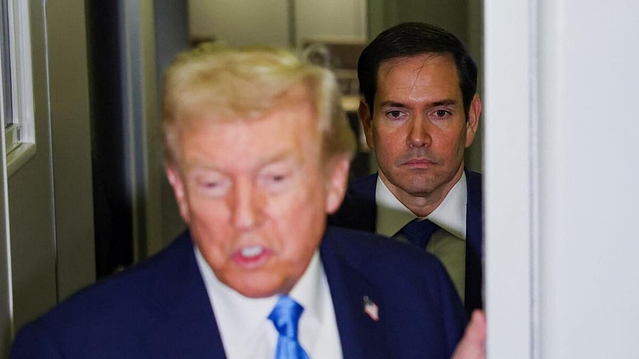 <div class="paragraphs"><p>US Secretary of State Marco Rubio looks on while US President Donald Trump speaks to the media</p></div>